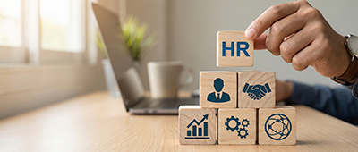 wooden building blocks representing business departments with HR on the top