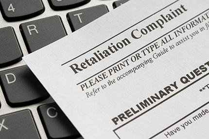 photo of a retaliation complaint form from a company laying on top of a keyboard
