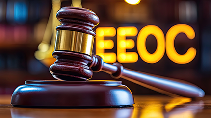 photo of a gavel and the letters EEOC enlarged in the background