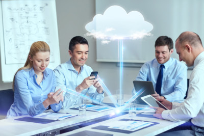photo of businesspeople using cloud computing sitting at a conference table 