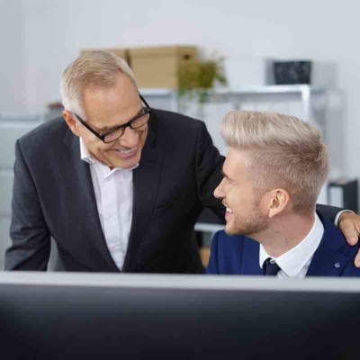 A picture of a manager encouraging a male millennial employee