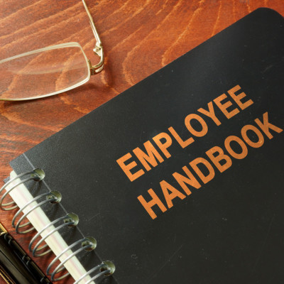 Picture of an employee handbook sitting on a desk.