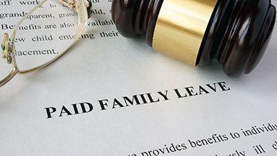 paid family leave act paperwork with judges gavel resting on top