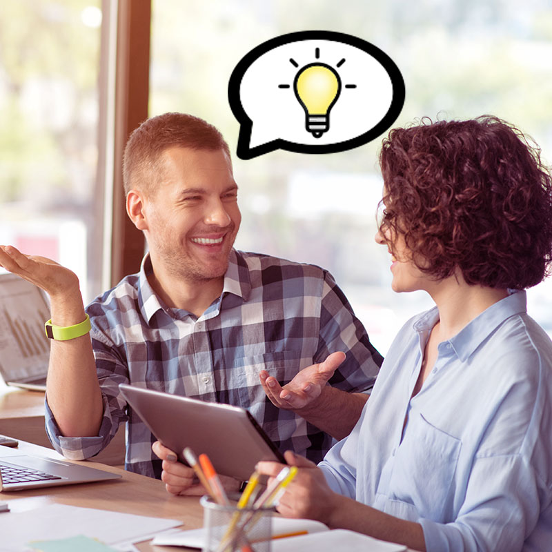 picture of a manager listening to an employee's idea with a cartoon of a lightbulb overhead