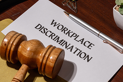 workplace discrimation folder with judge gavel on top