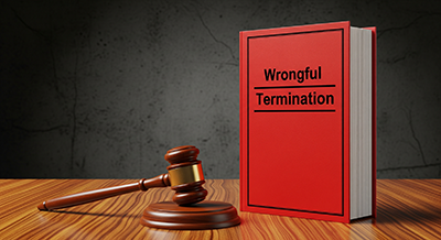 wrongful termination legal journal with judges gavel next to it